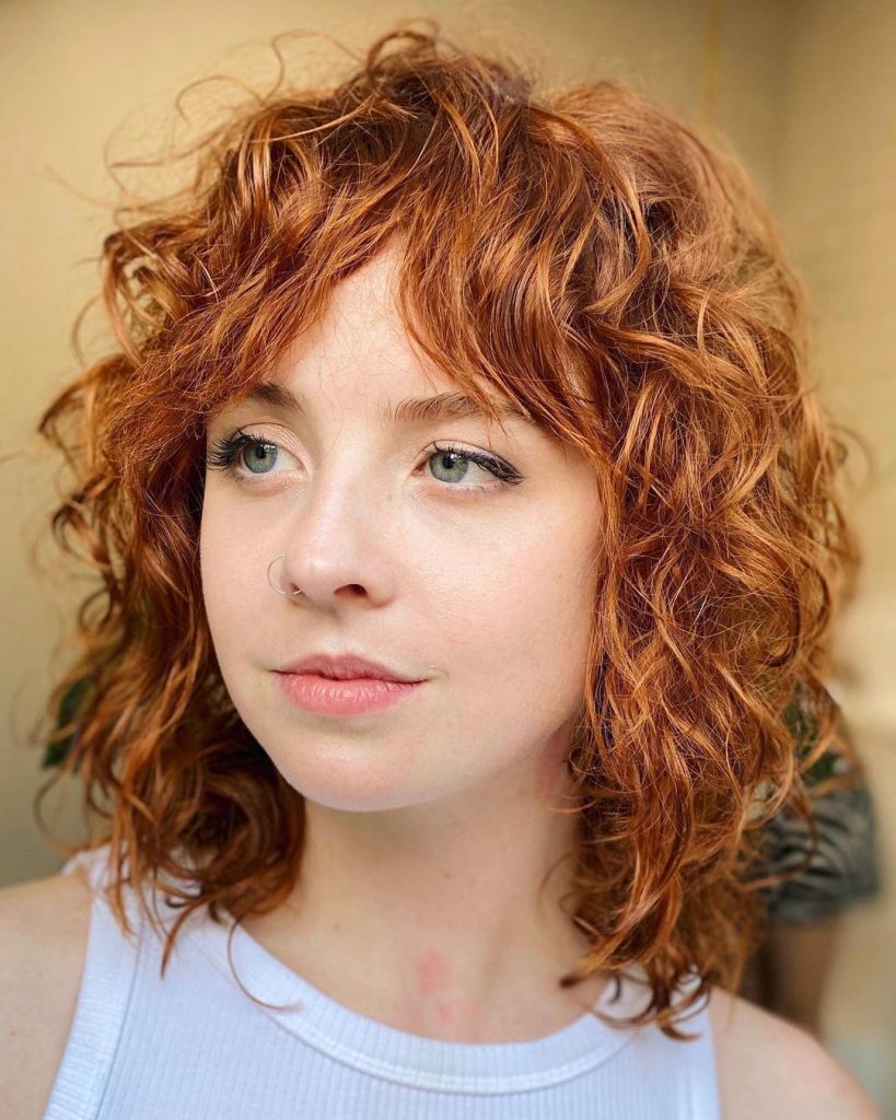 Short curly hair with curtain bangs
