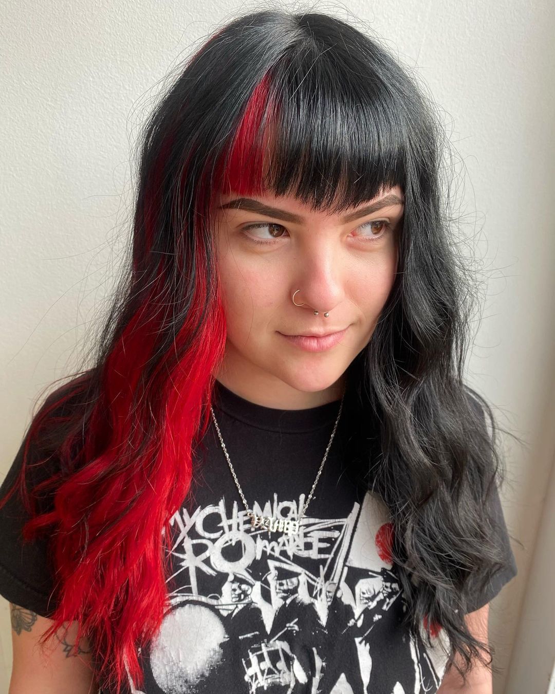 capelli neri con riflessi rossi su un lato