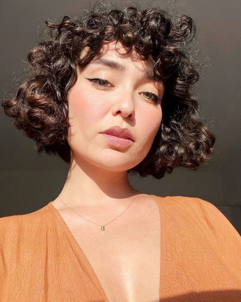 curly french bob with bangs