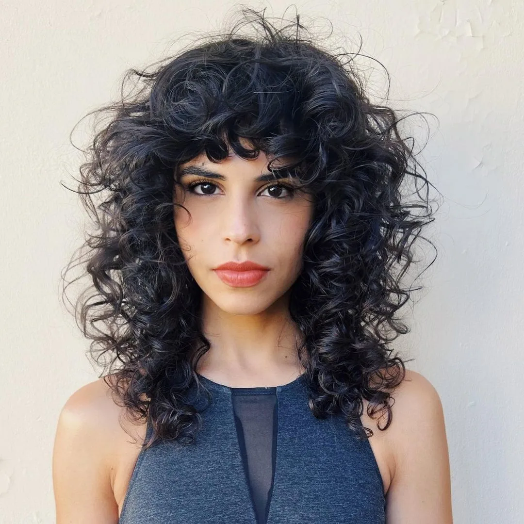 woman with an effortless mid-length curly shag hairstyle 