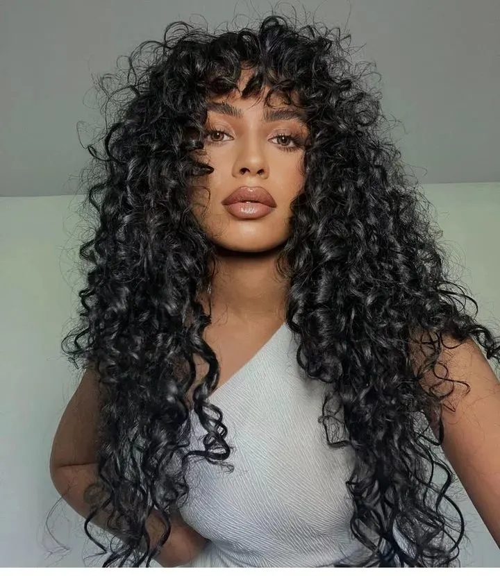 long curly hair with layers and bangs