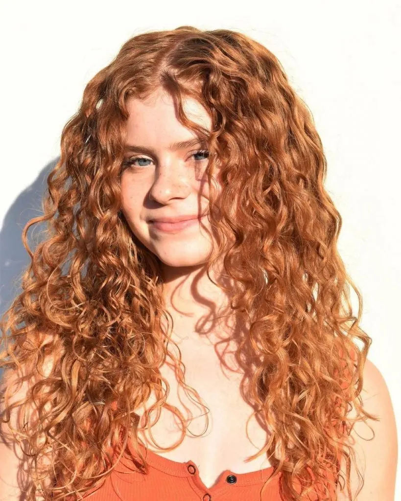 long ginger curls with a middle part