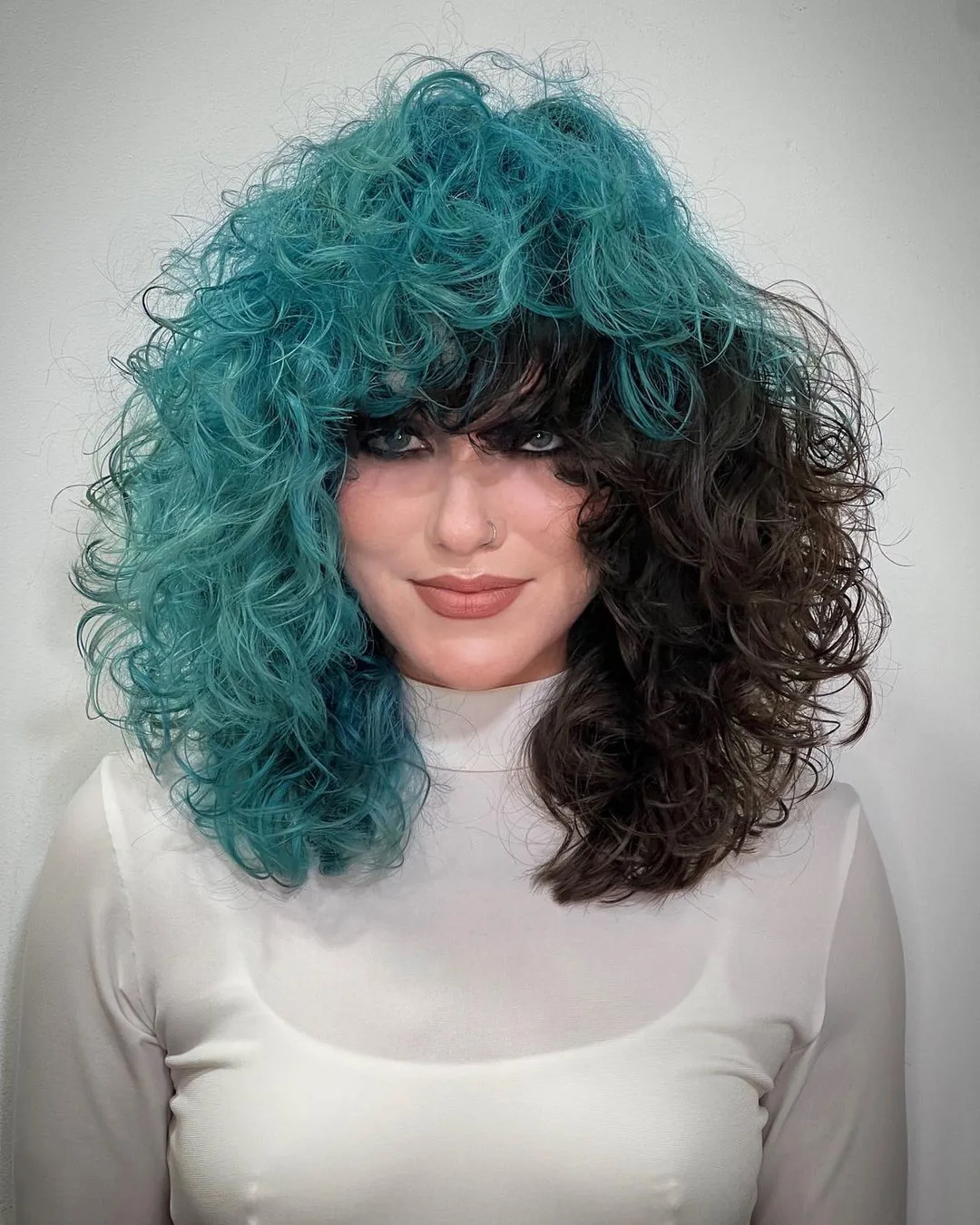 a young woman with mid length color blocking curls