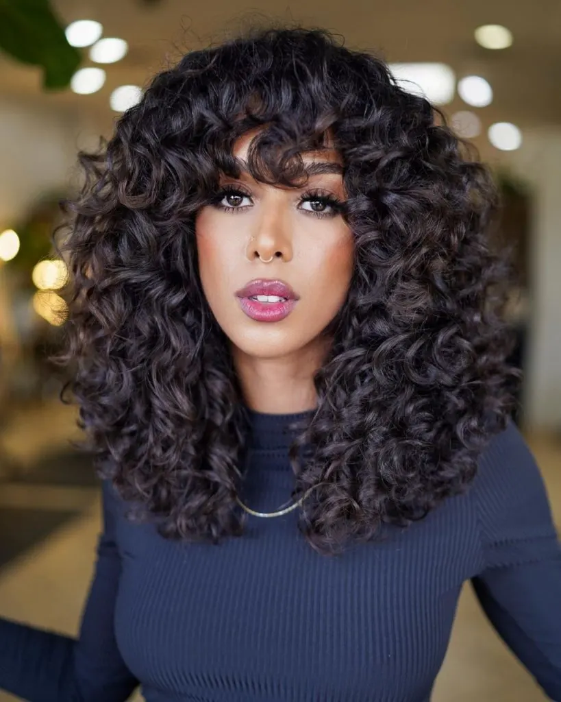 thick curly hair with bangs
