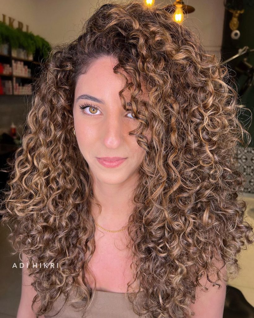 caramel curly hair with highlights