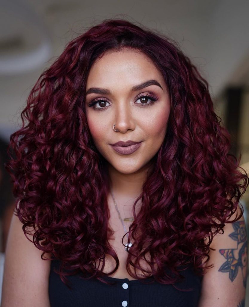 a woman with cherry pop curly hairstyle 