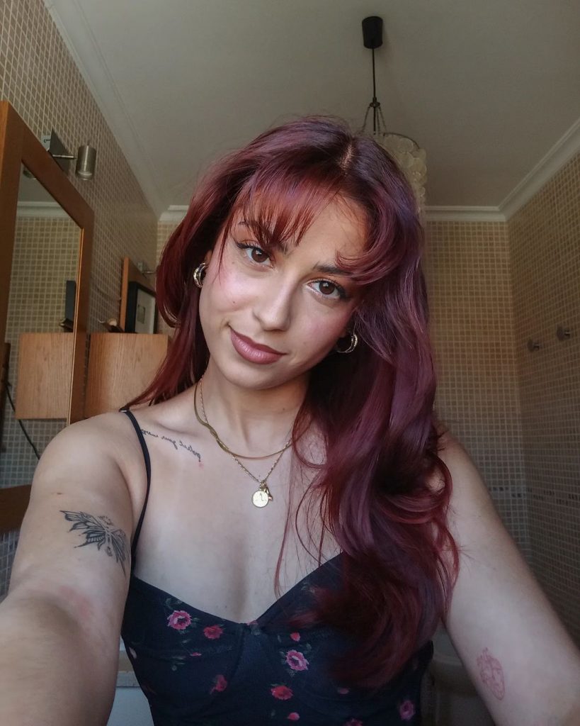 cherry red hair with wispy bangs