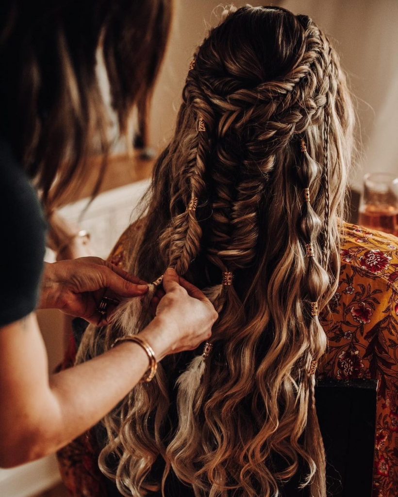 accessorized bubble braids and fishtail braids on a wavy hair