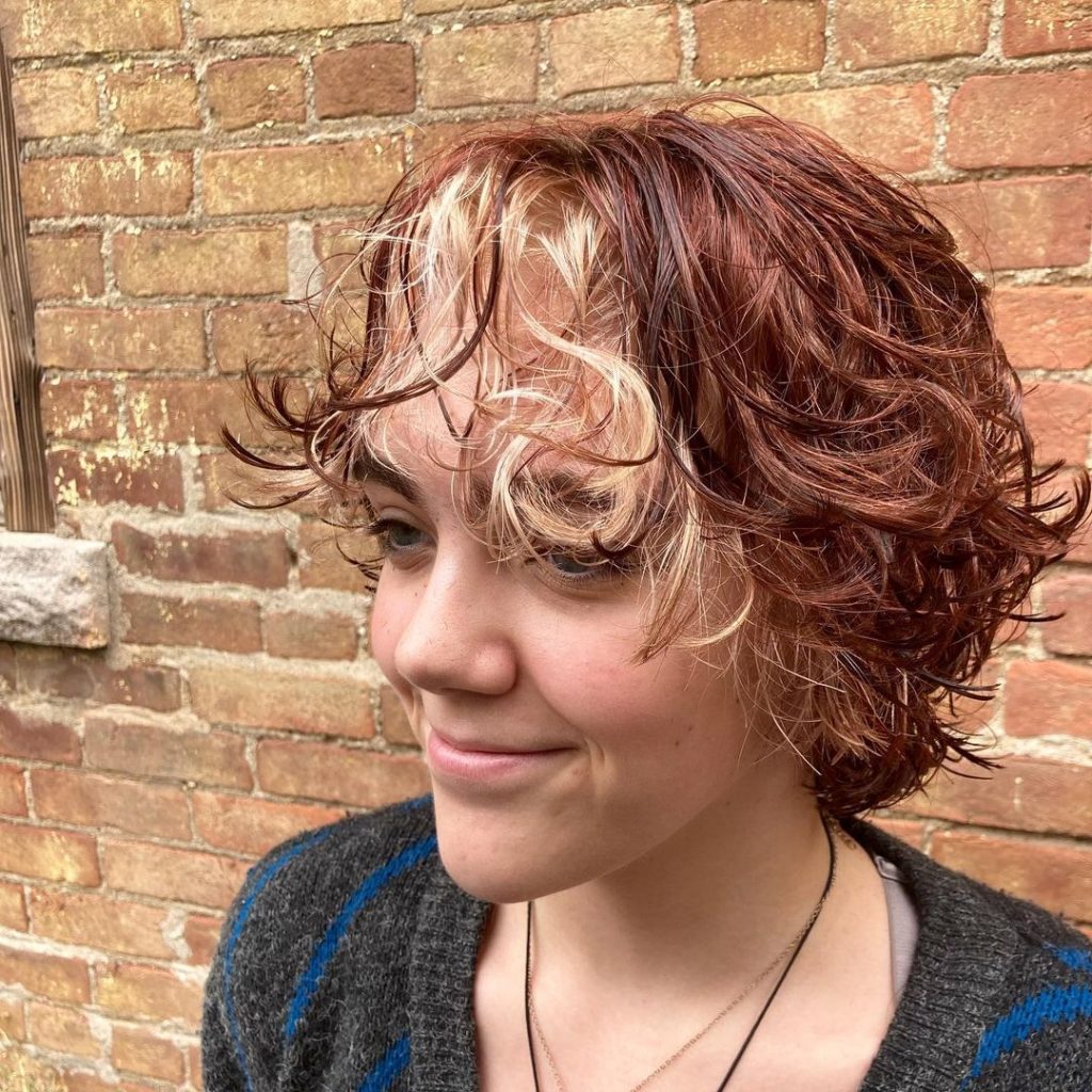 curly red bixie cut with blonde highlights