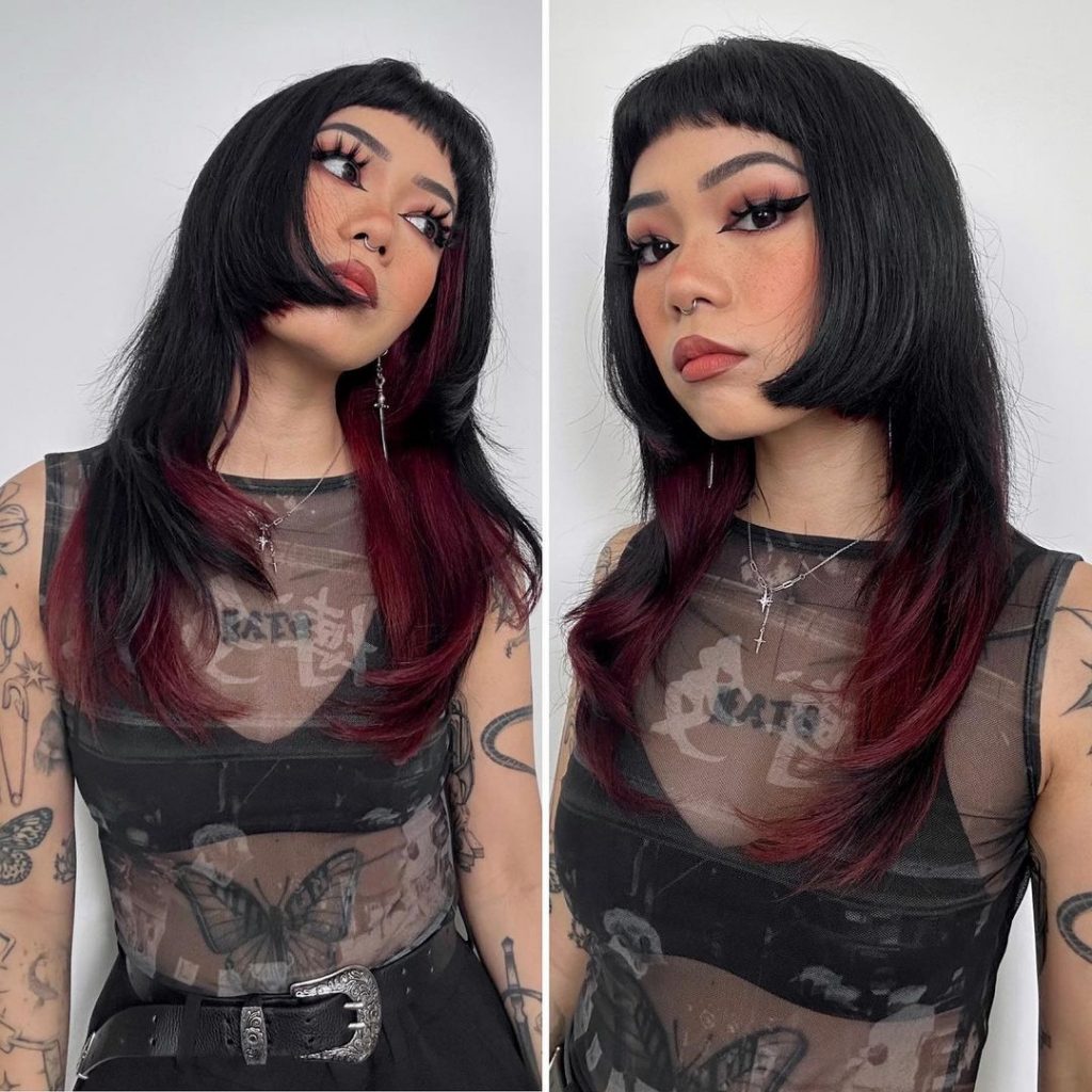 edgy cherry red and black haircut