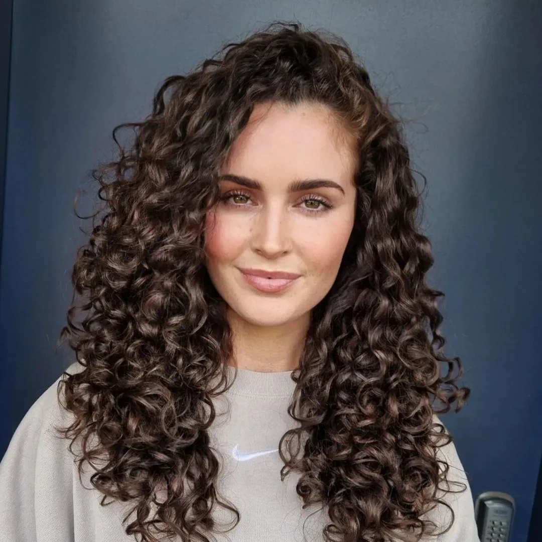 long curls with deep side part and waterfall layers
