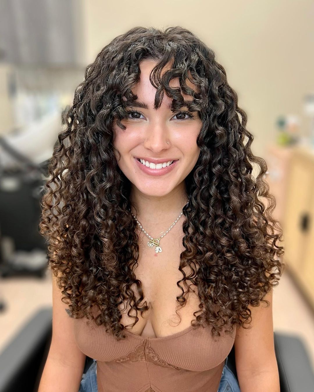 long layered curly hair with piecey bangs