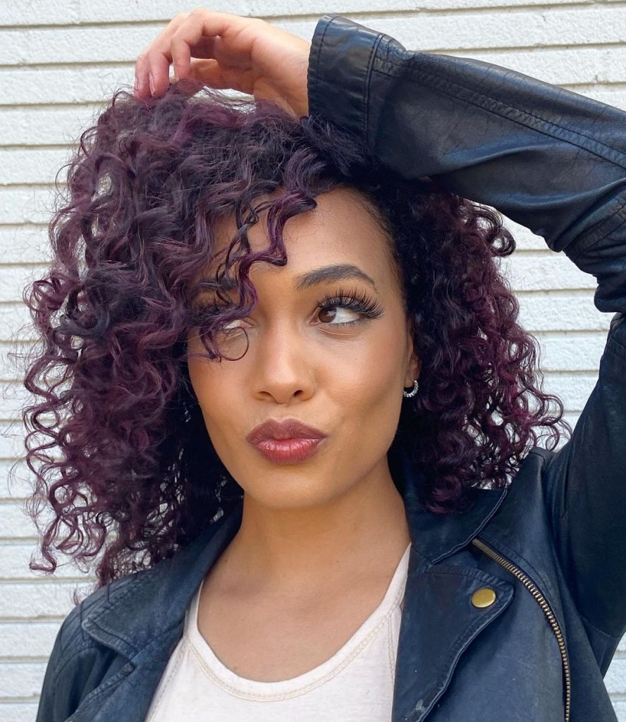 short curly hair with eggplant purple highlights