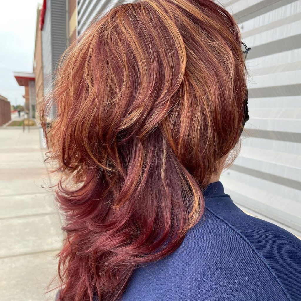 red butterfly cut with blonde highlights