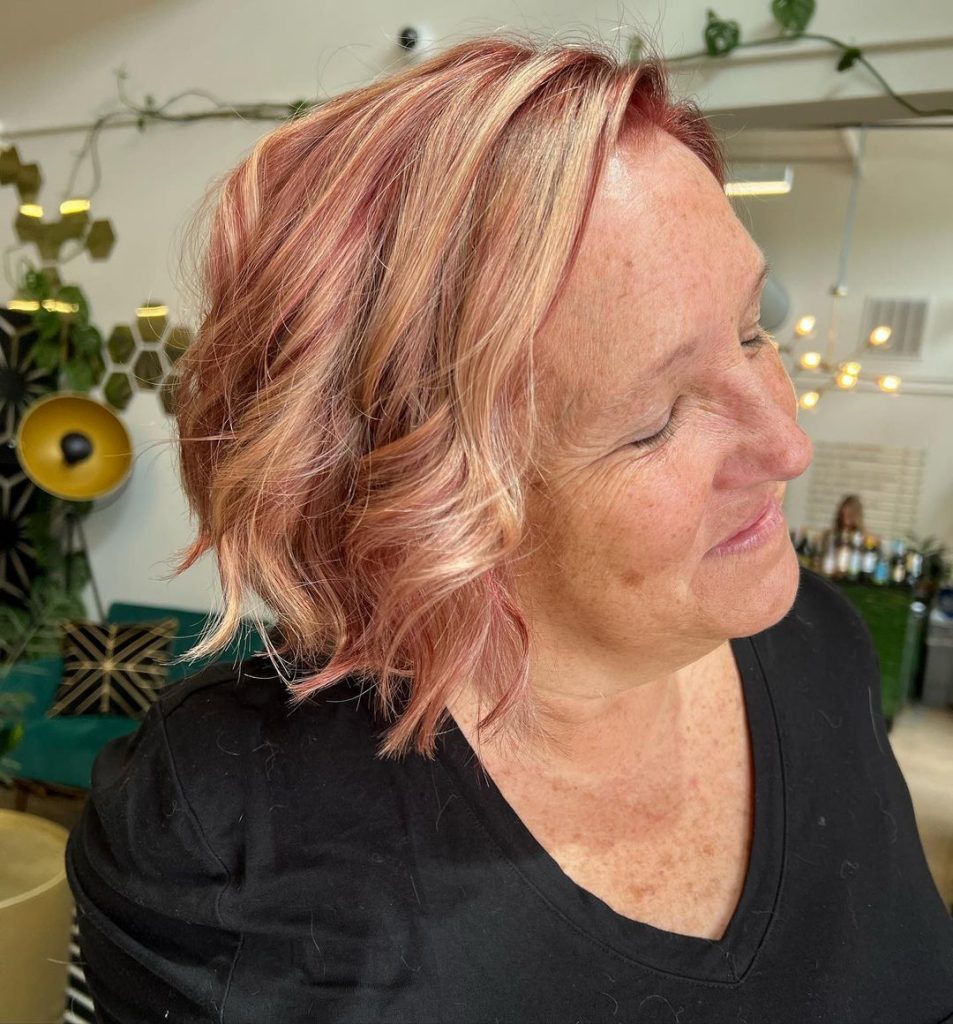 red curly bob with blonde highlights