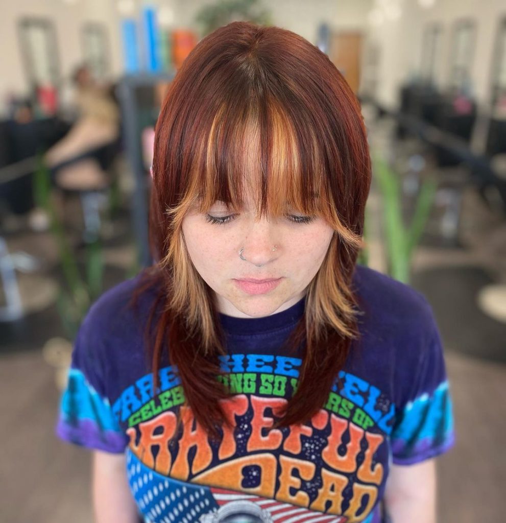 red layered cut with blonde bangs and face framing highlights