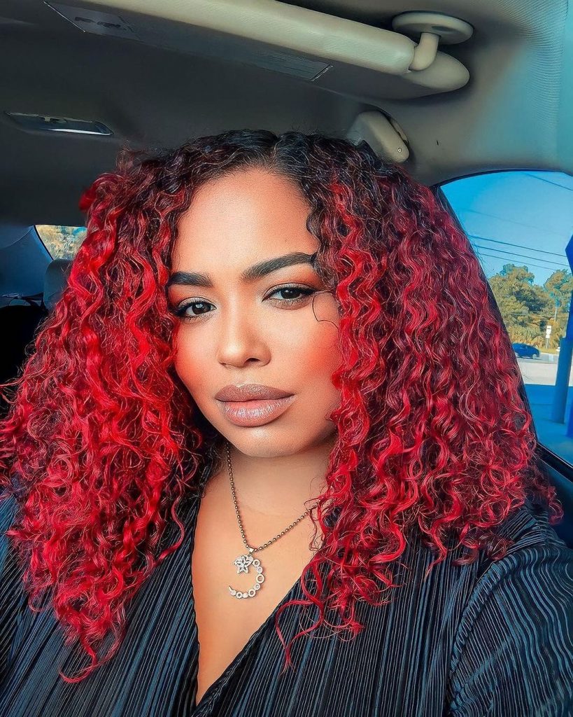 vibrant red curls with dark roots