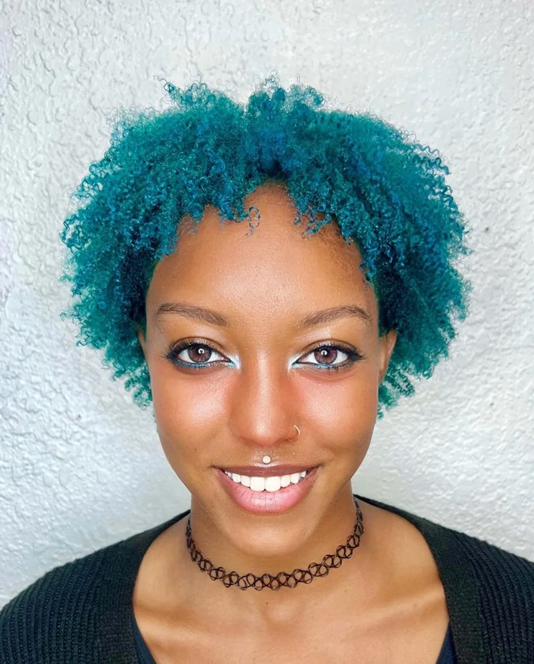 short curly choppy haircut for 4C curls in pastel blue color