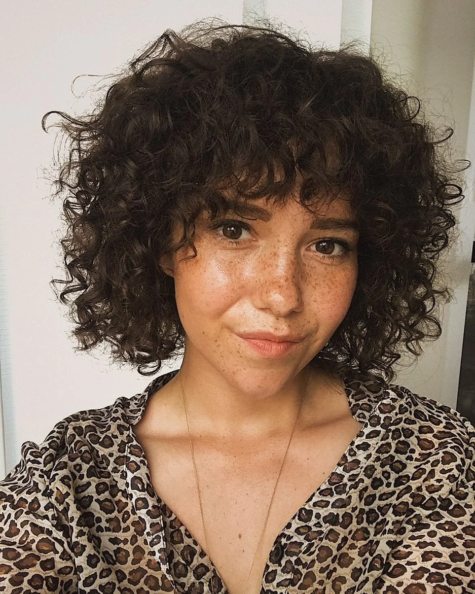 short curly haircut with bangs