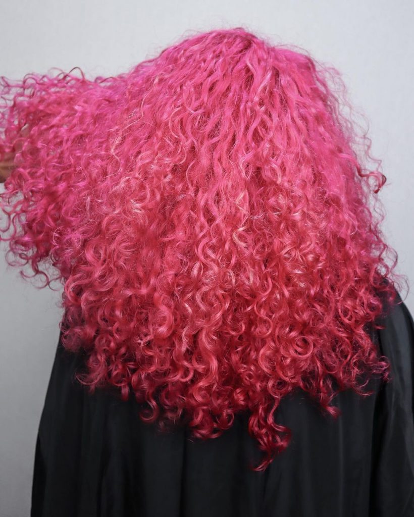 vibrant bubble gum pink curly hair