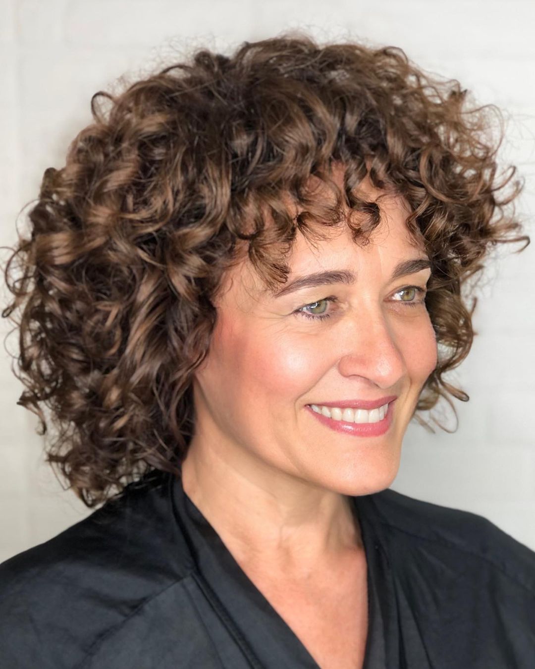 curly bob with bangs for older women