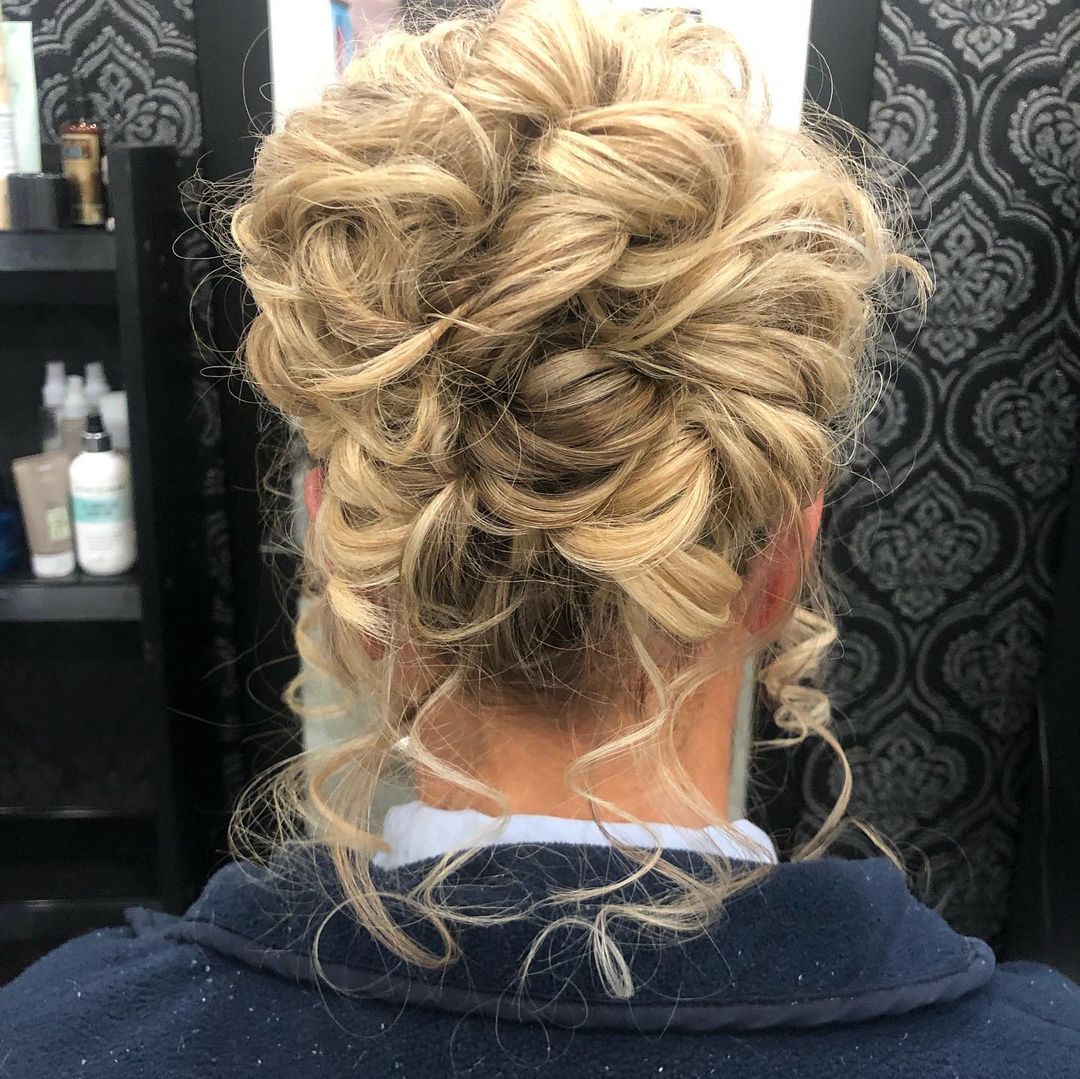 curly hair updo with loose strands