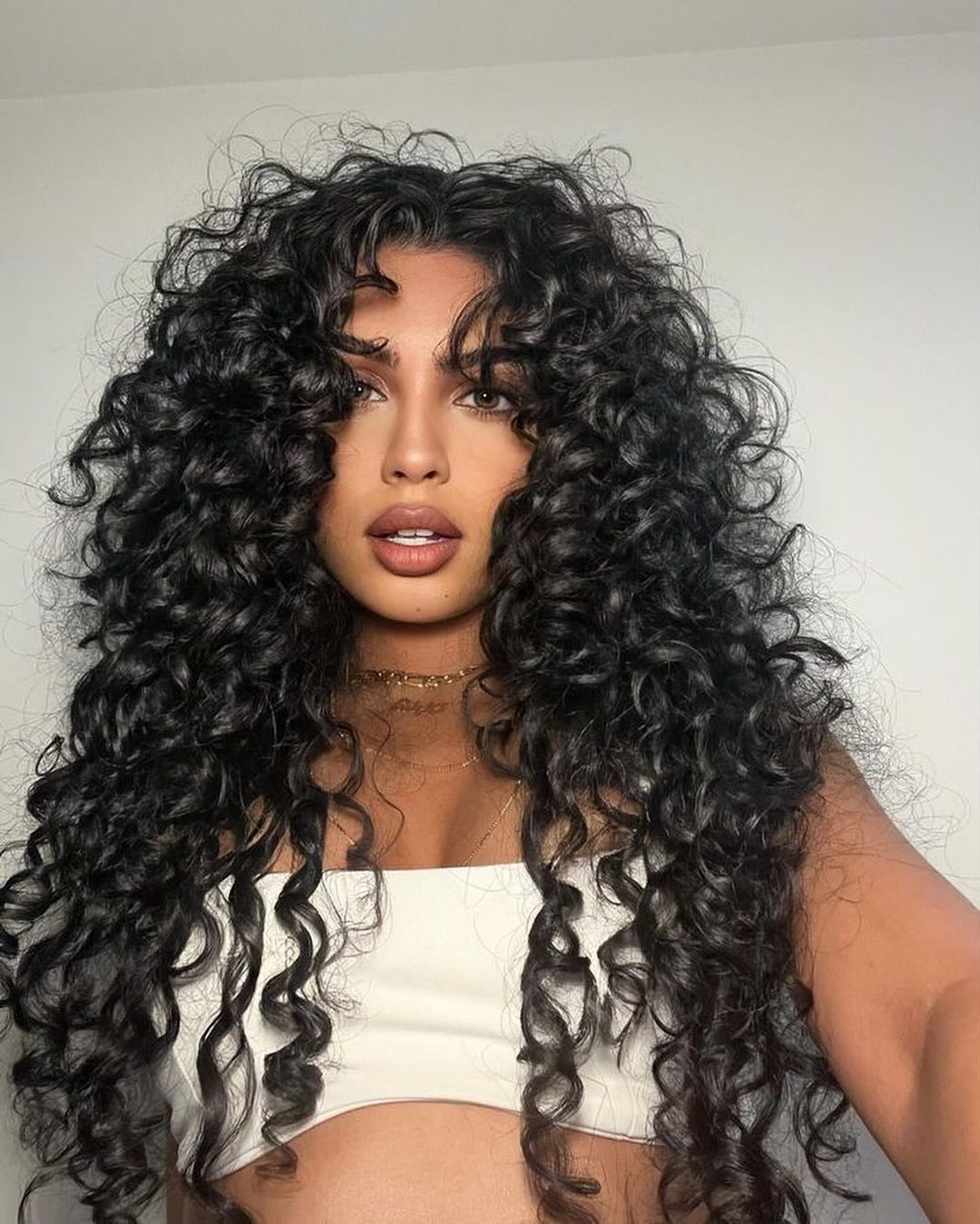 ultra long black curly hair with face framing layers