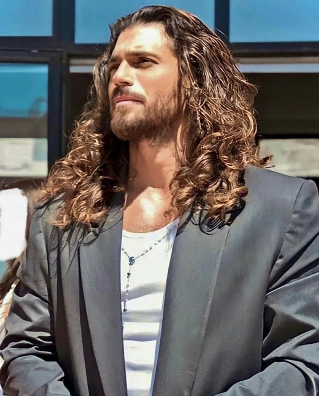 a man with long curly hair