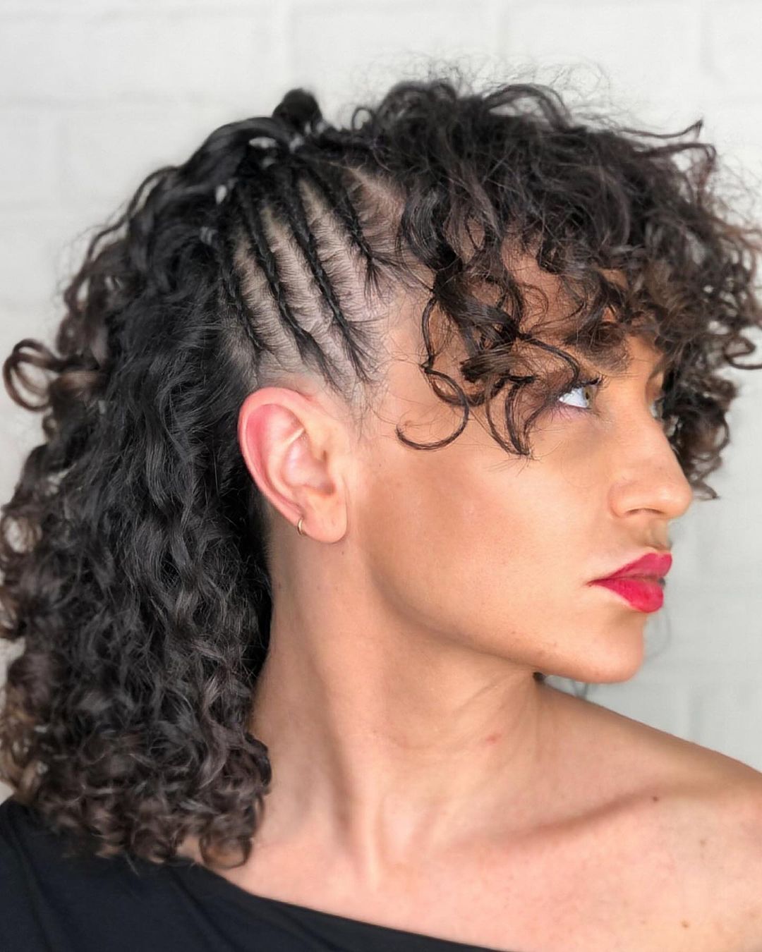 medium length curly hairstyle with side cornrows