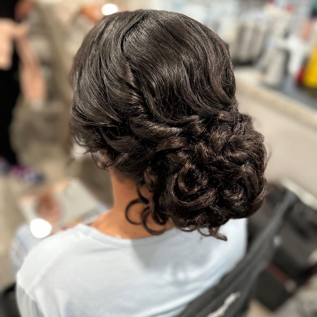 elegant low bun updo for curly hairstyles