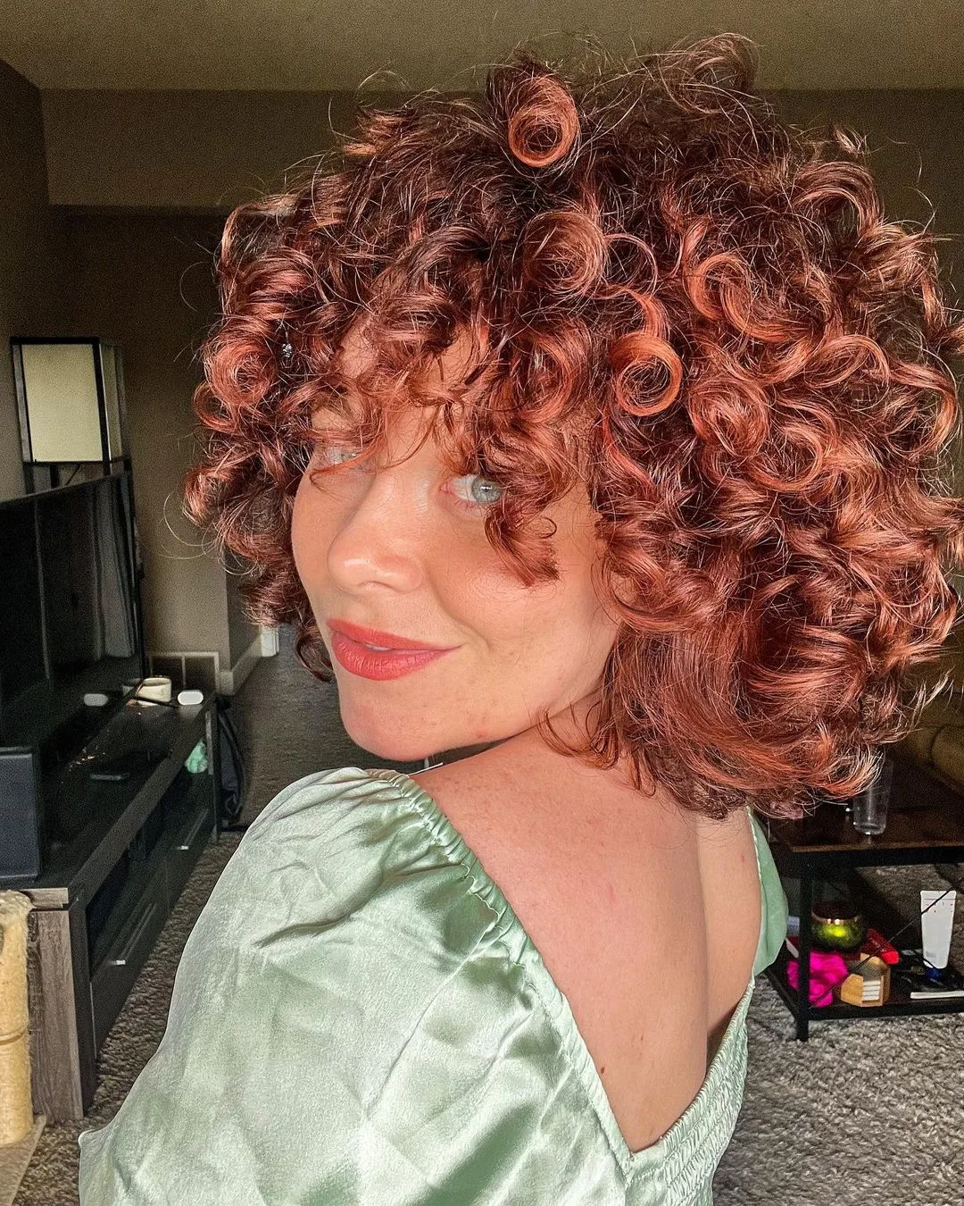 short curly hair with red highlights