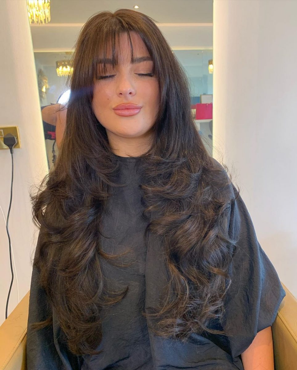 Long hair with feathered choppy layers for added volume and movement