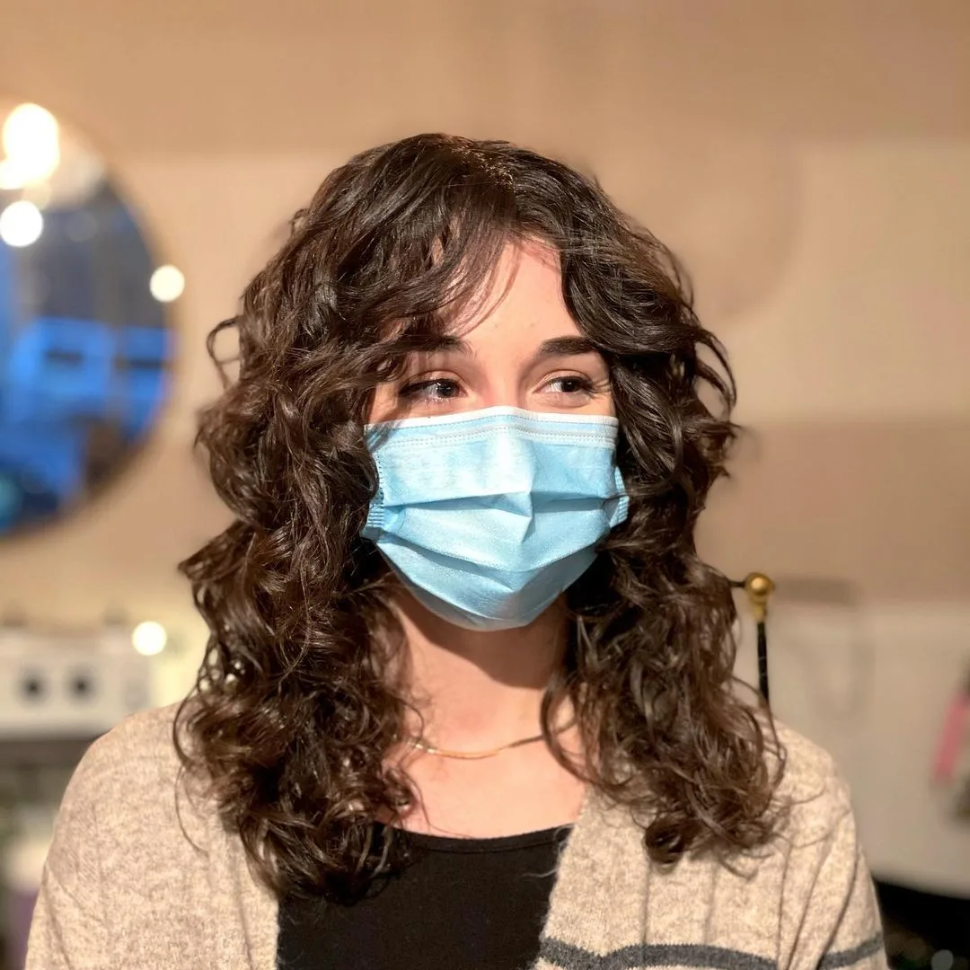 22 Flattering Ways To Pair Curtain Bangs With Curly Hair