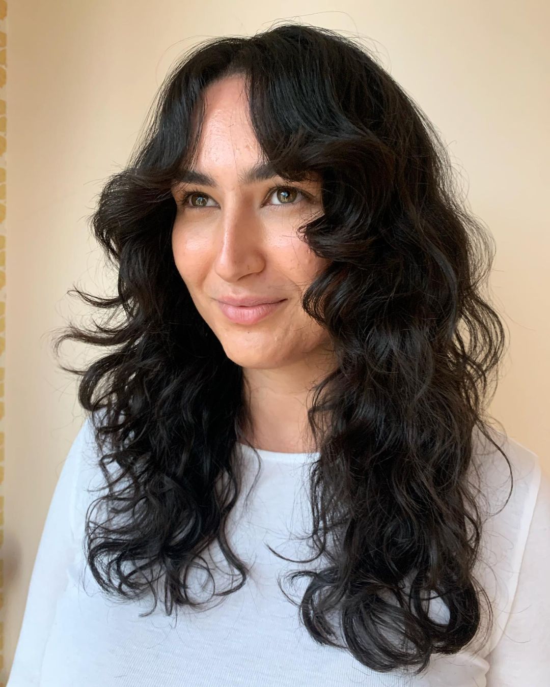 black curly hair with curtain bangs