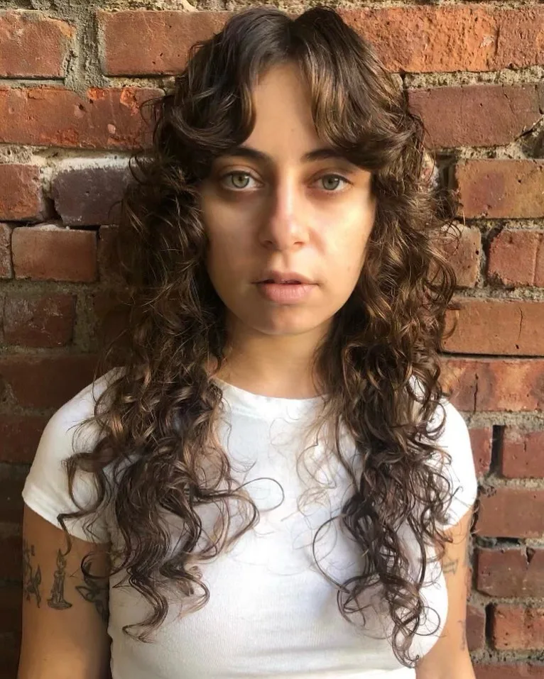 curly hair with flipped curtain bangs