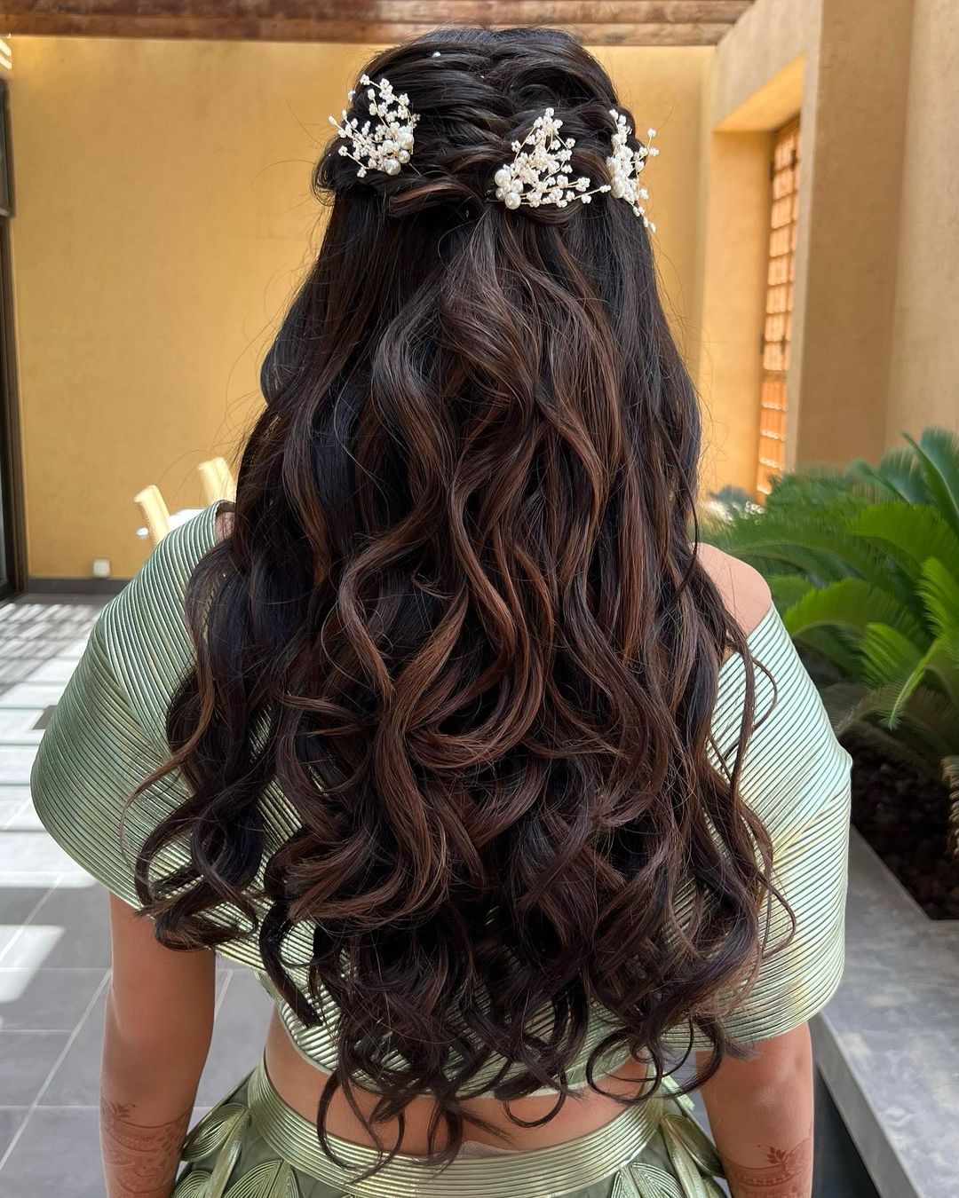 half-up braided waves with flowers on long brown hair