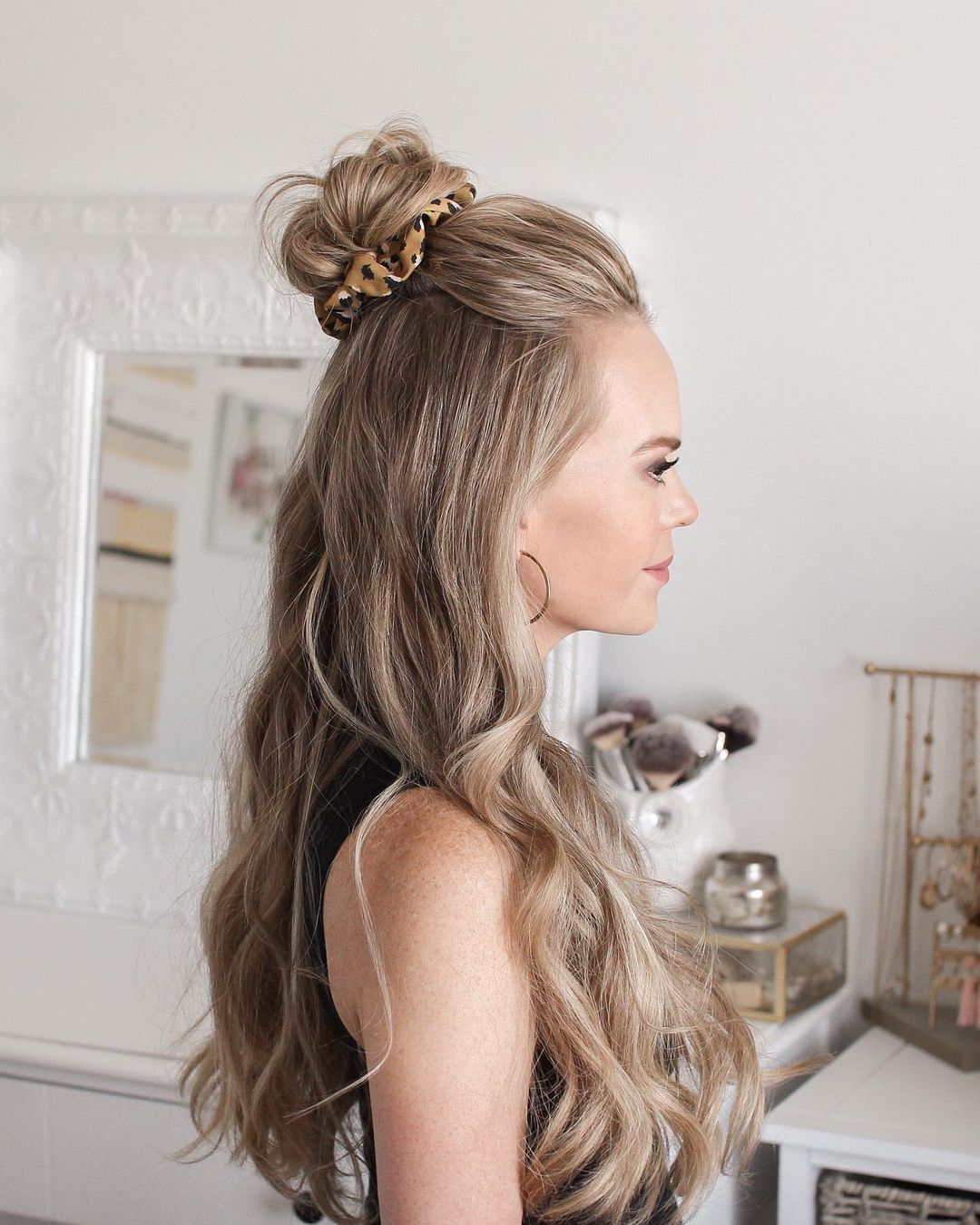 half up top knot for long wavy hair