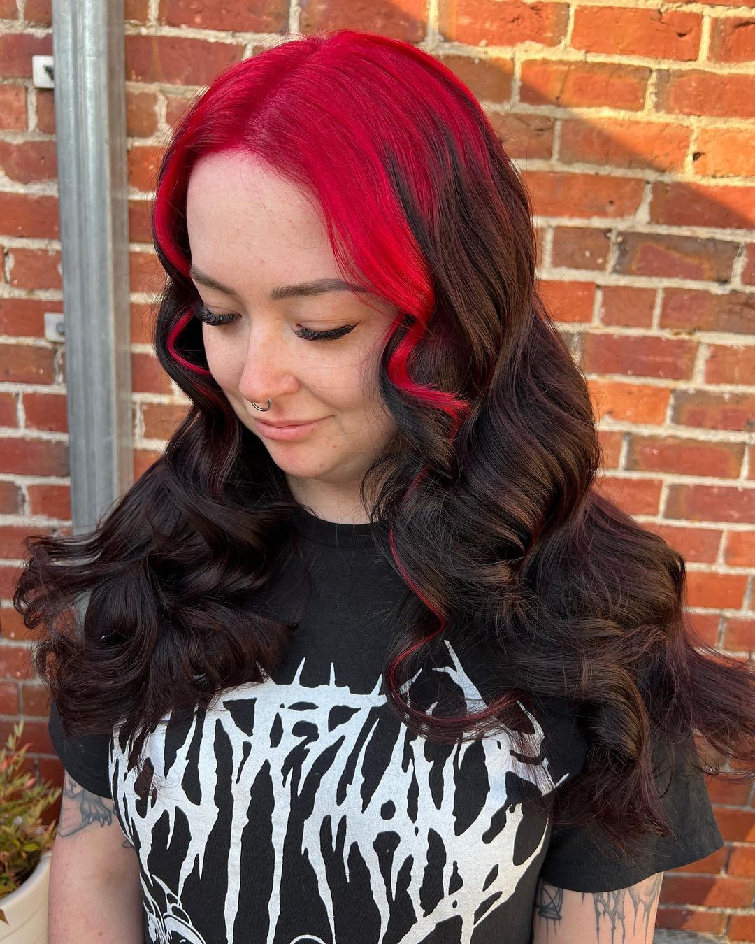 red roots and money piece on black curled hair