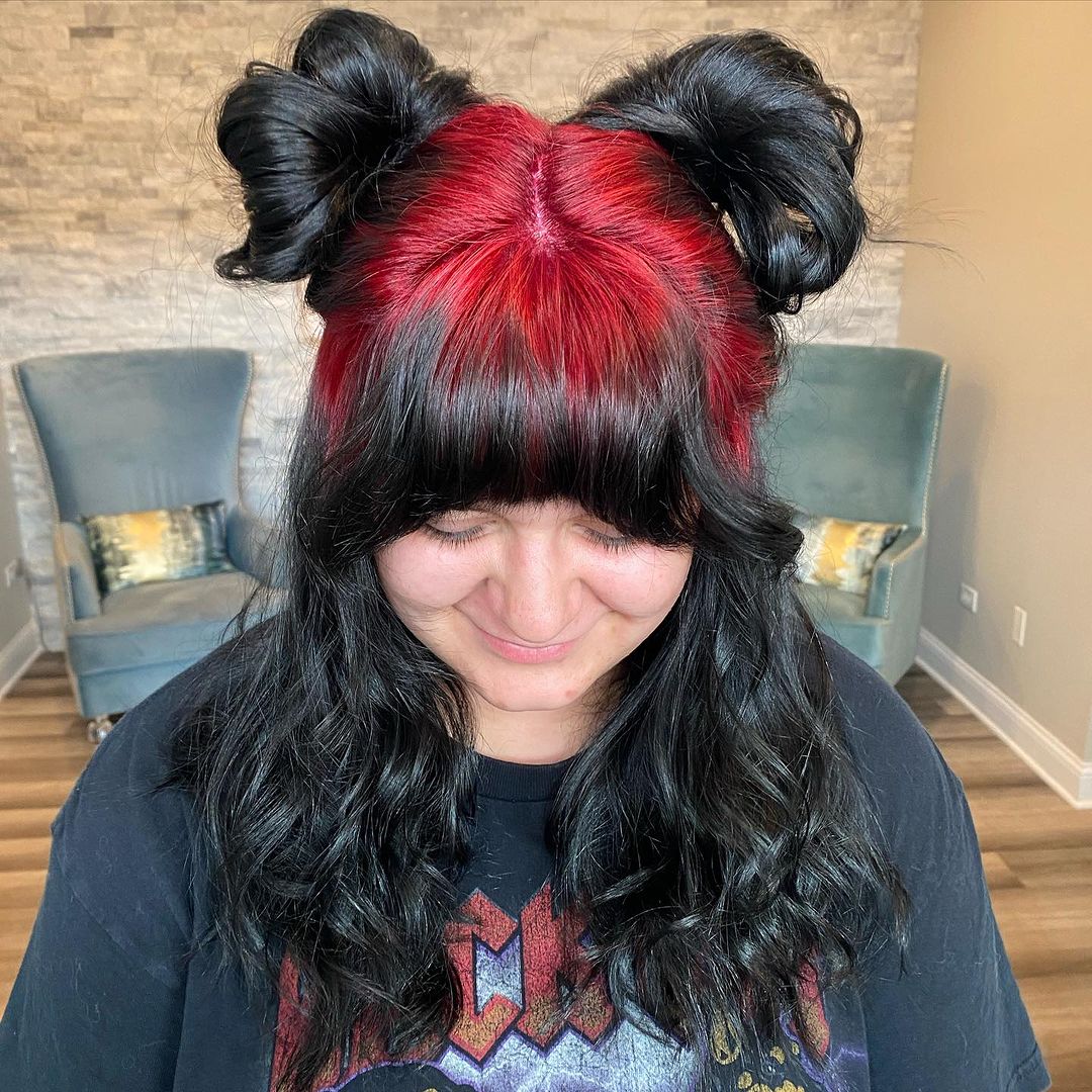 red roots black hair on pig tail buns