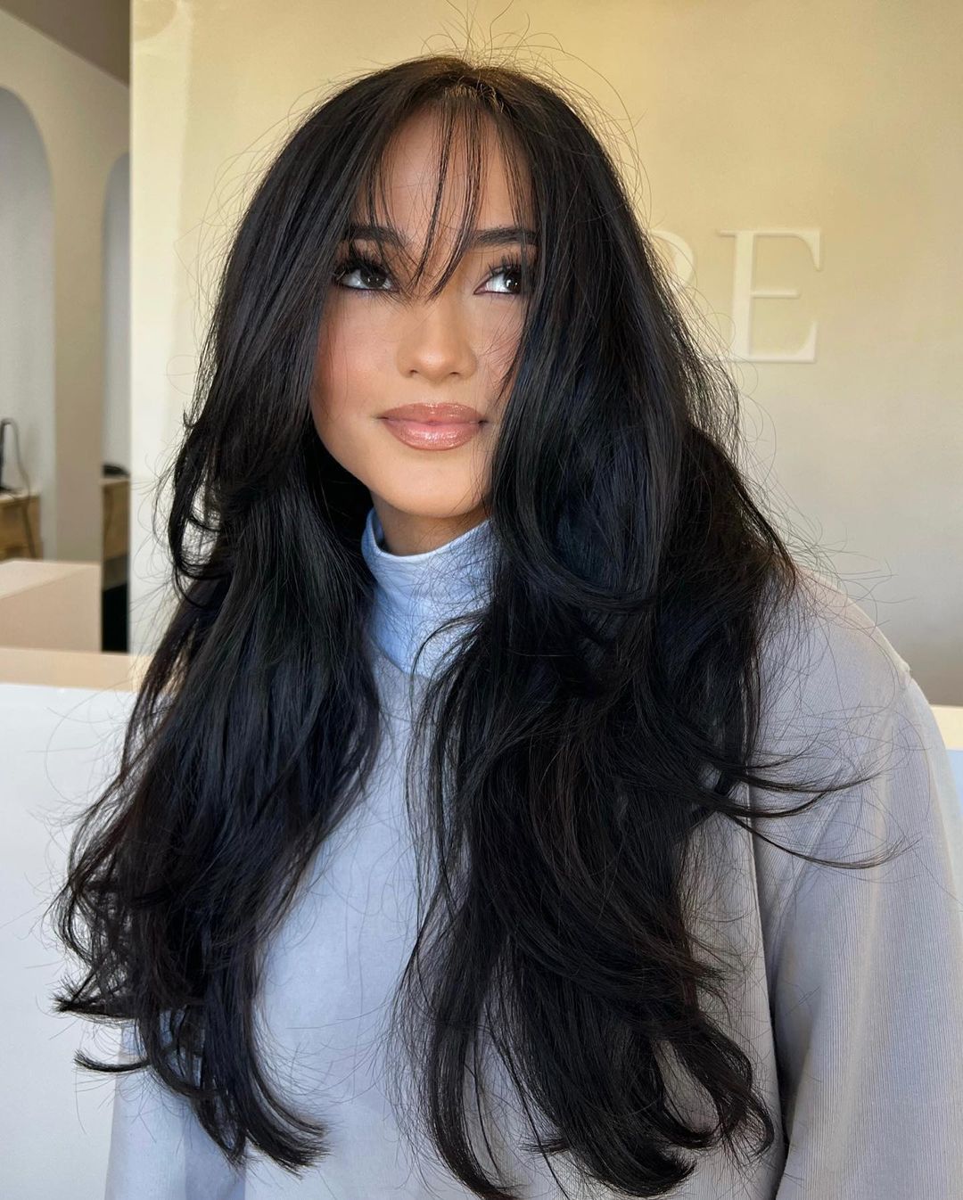 wispy curtain fringe on long black hair with layers