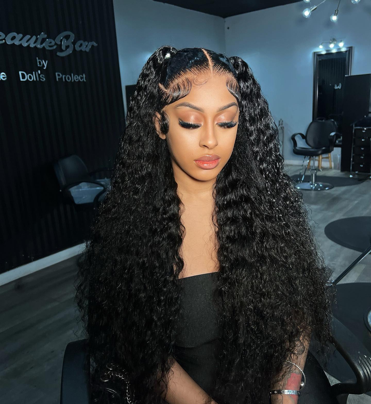 two high curly weave ponytails