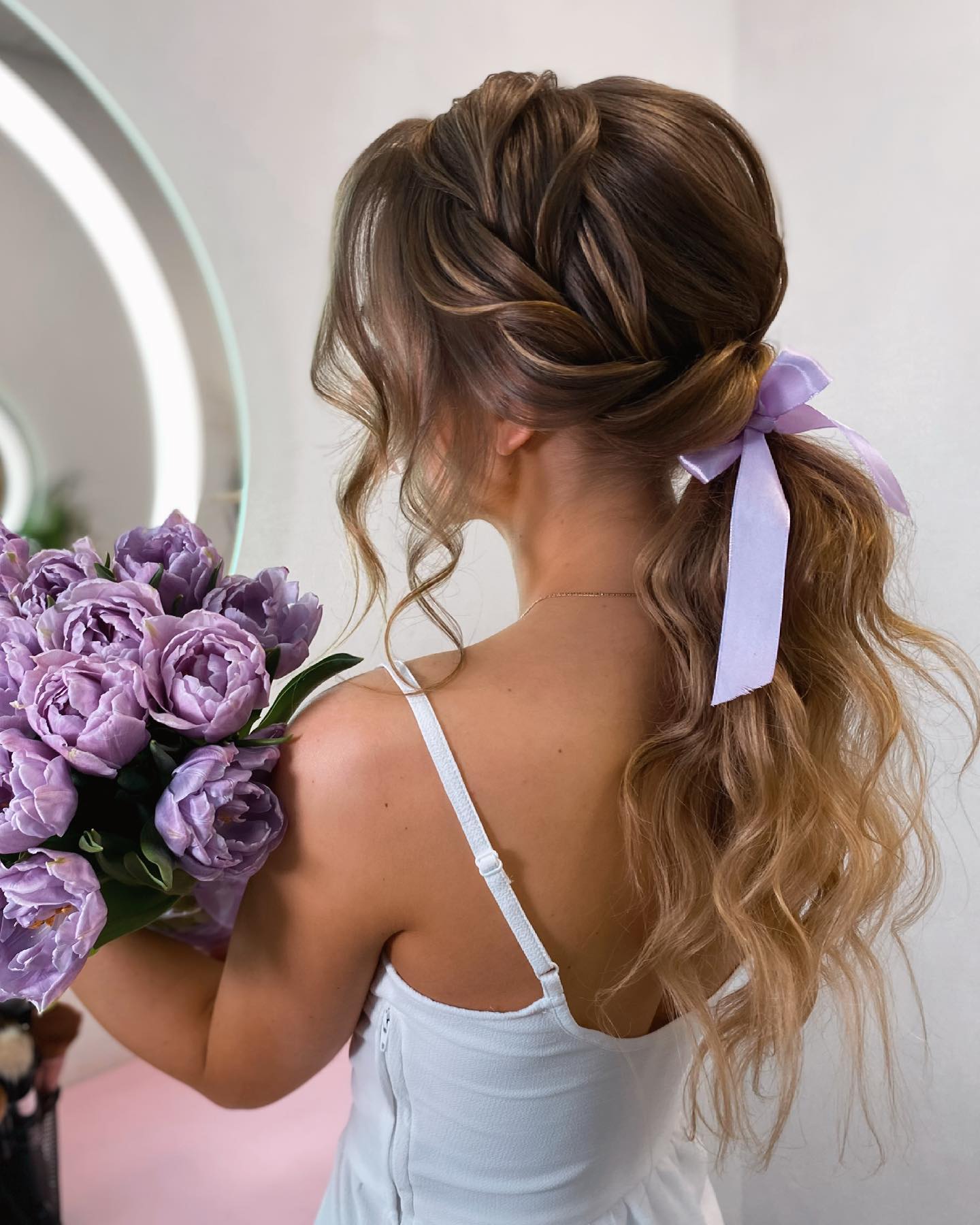low ponytail with bow and side braid