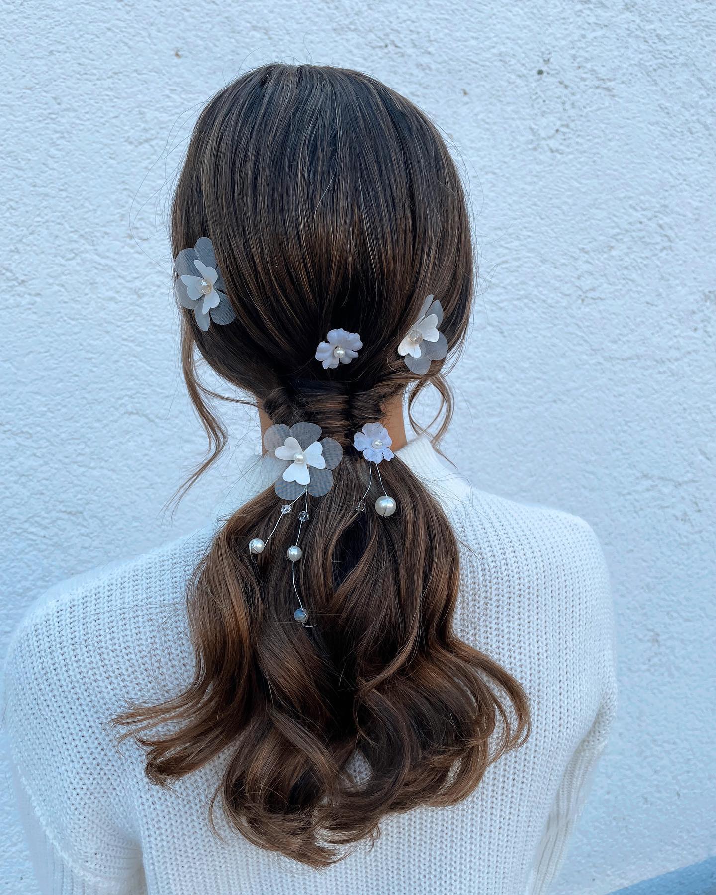 low ponytail with floral accessories