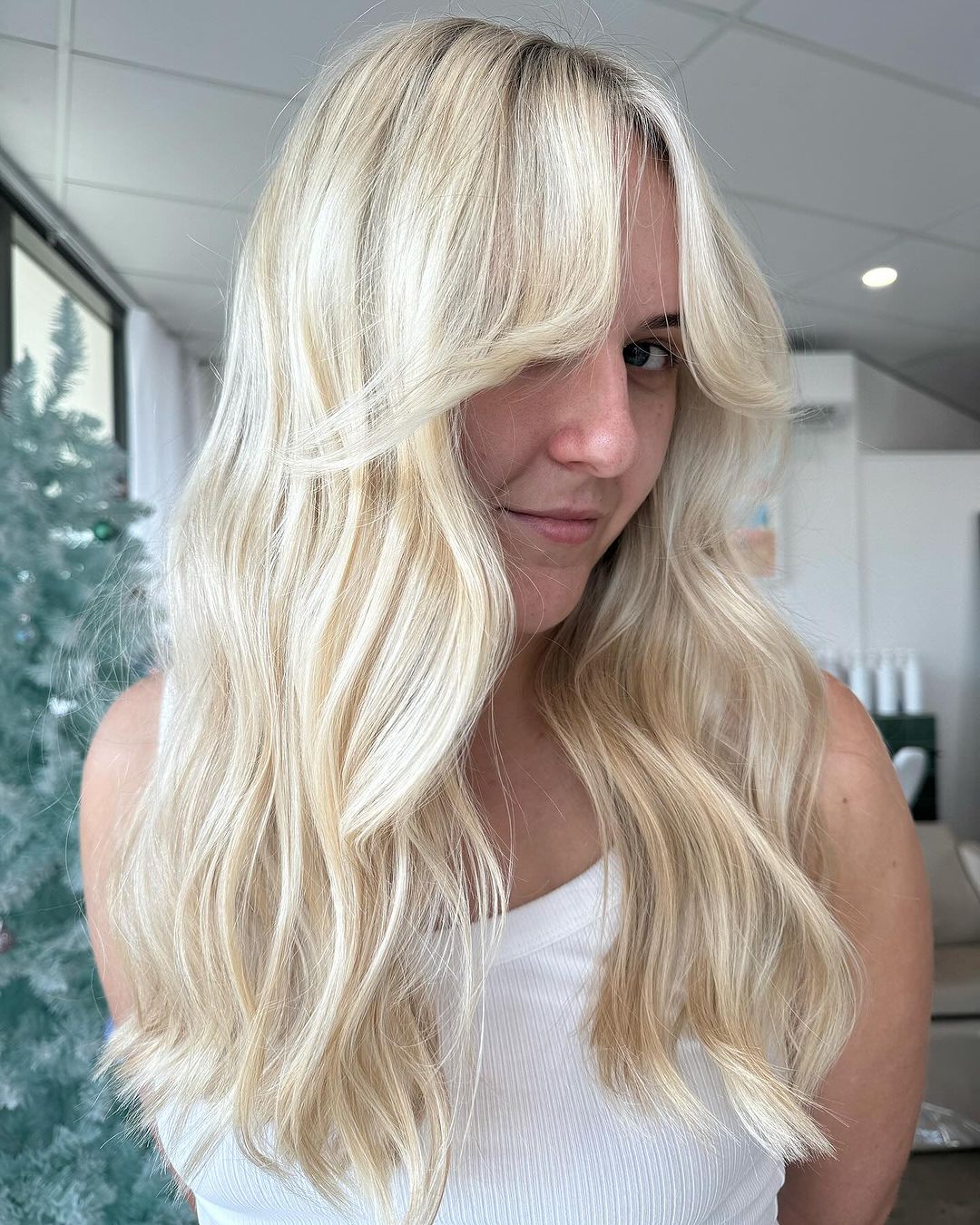 blonde layered hair with curtain bangs