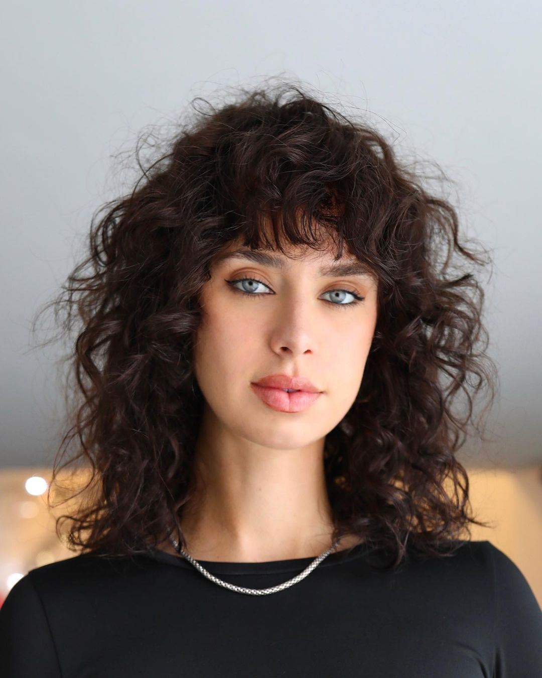 curly layered hair with bangs