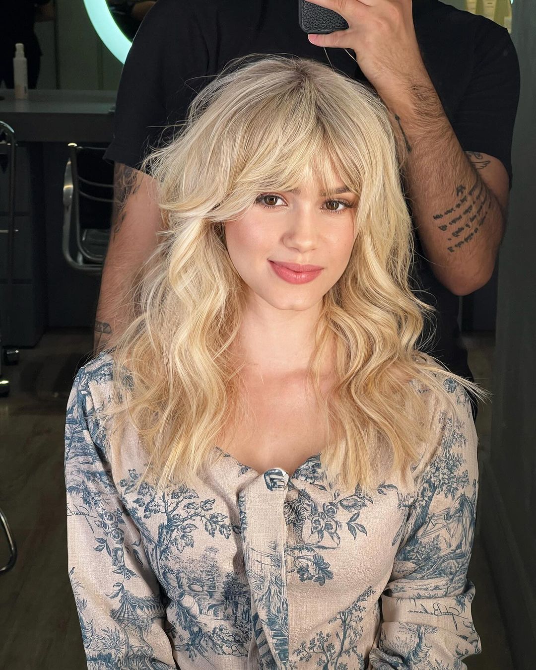 feathered curtain bangs on blonde wavy hair