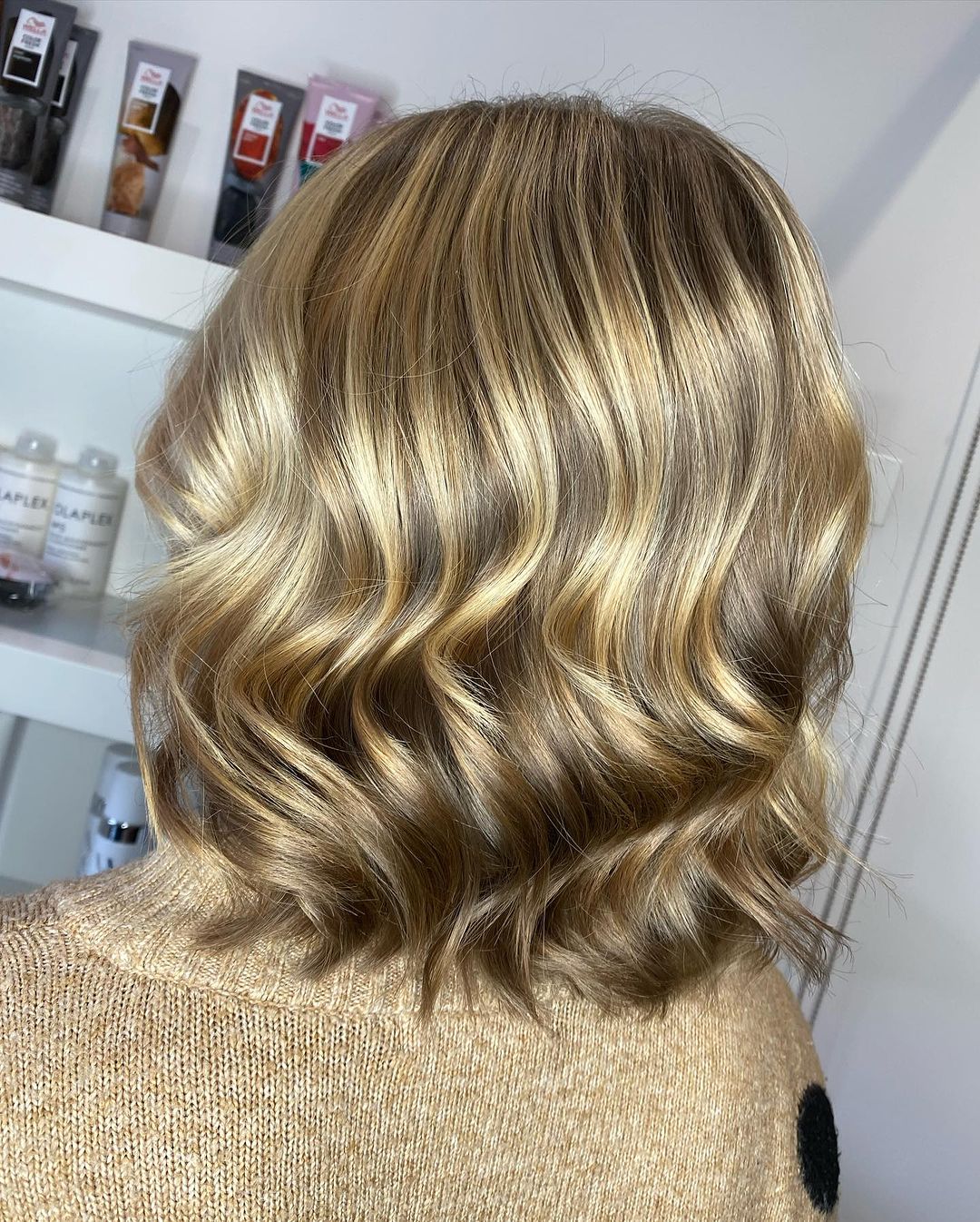 a woman with golden blonde layered wavy lob