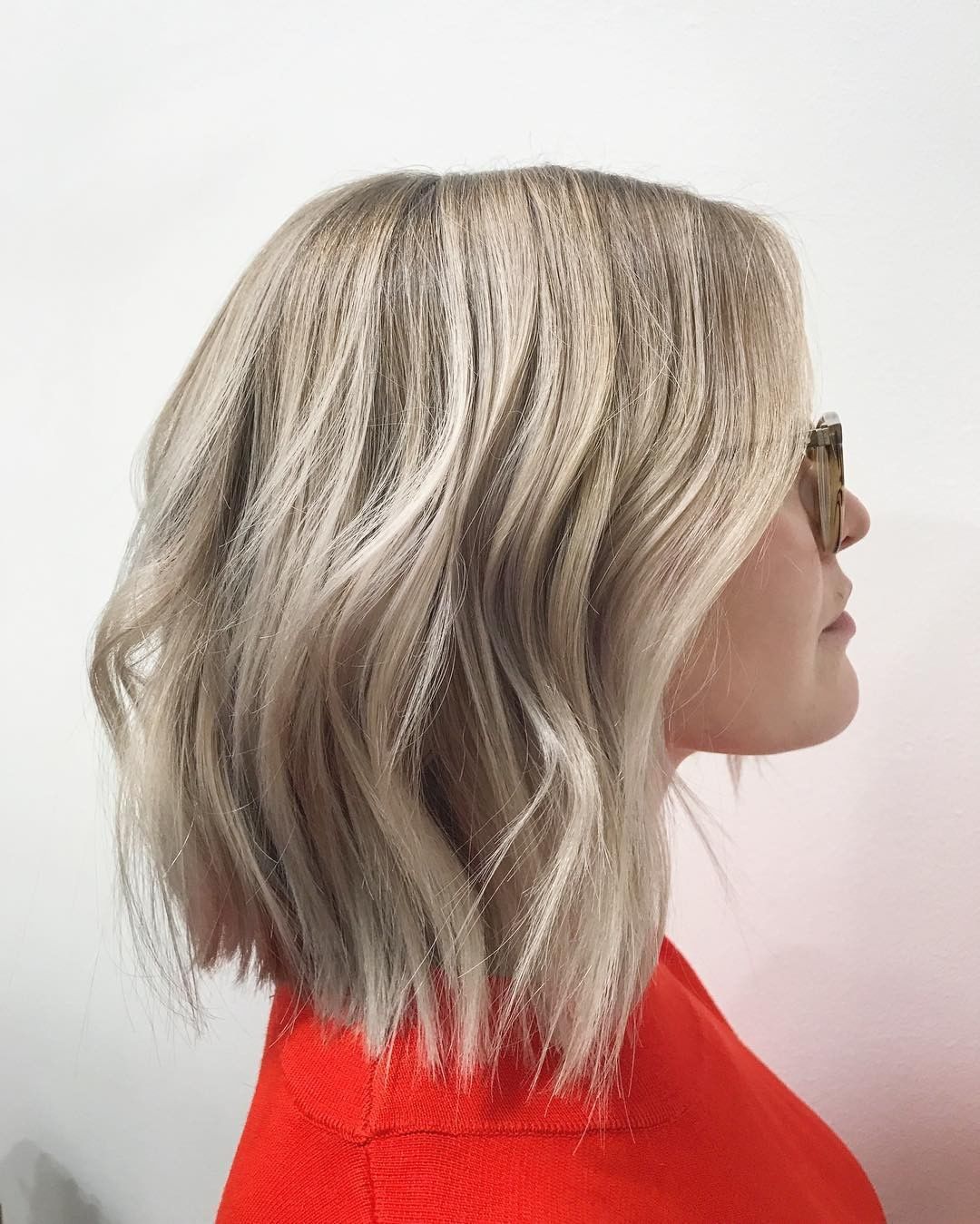 a woman with wavy blunt cut lob with highlights