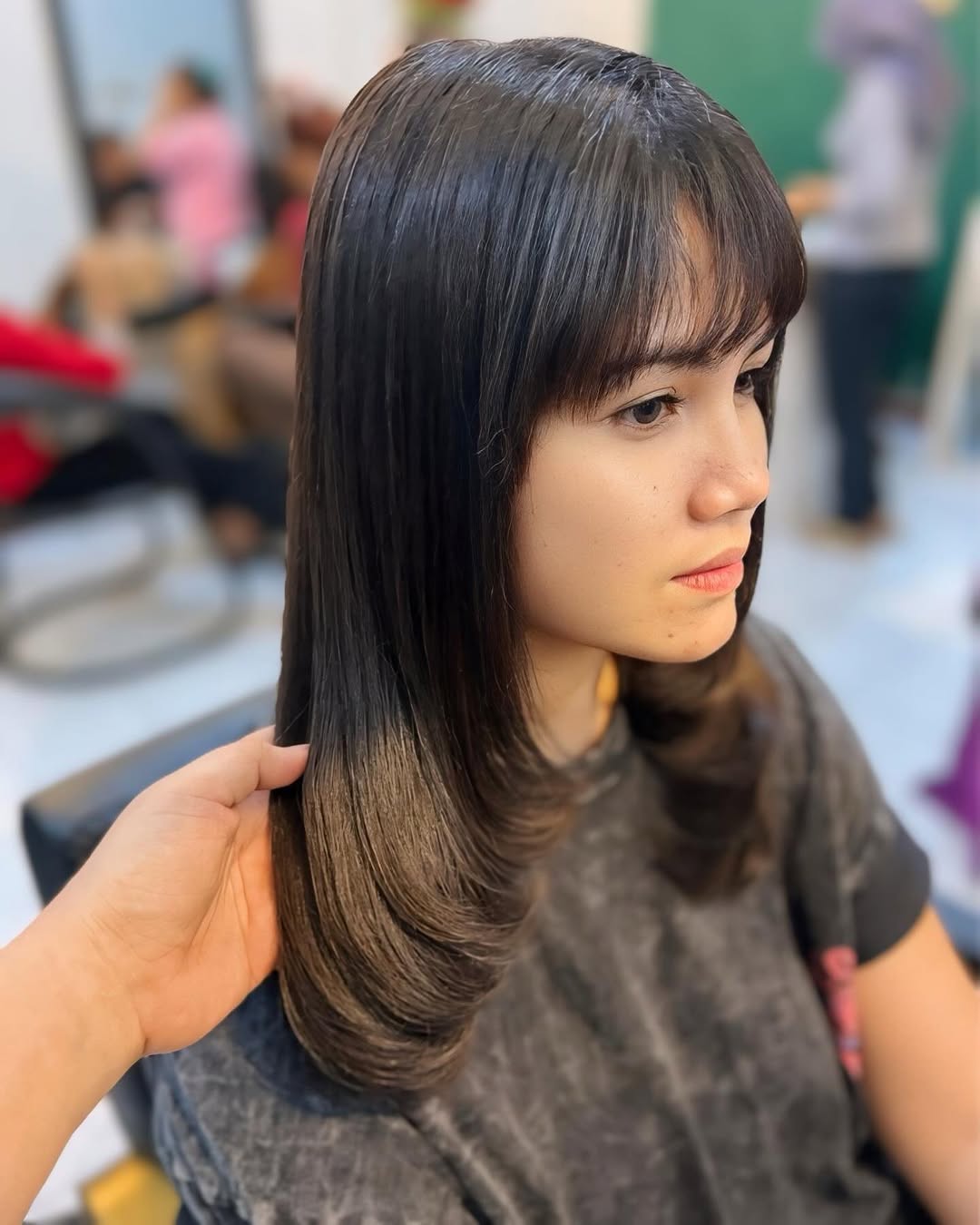 medium curve cut with wispy bangs