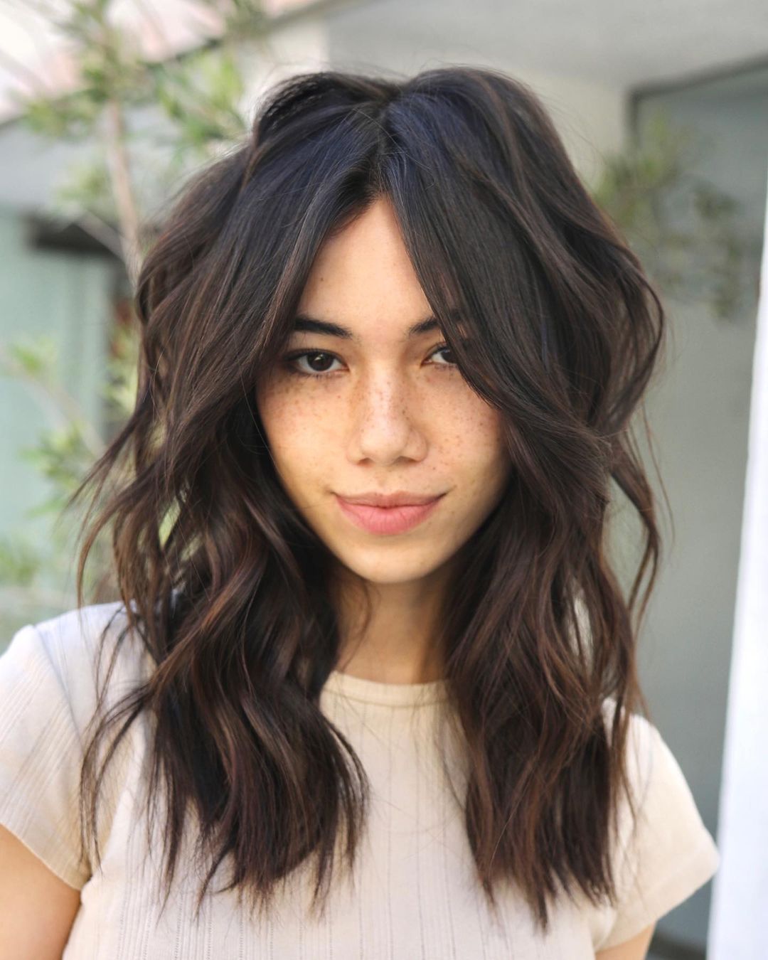 mid length choppy layers with long bangs